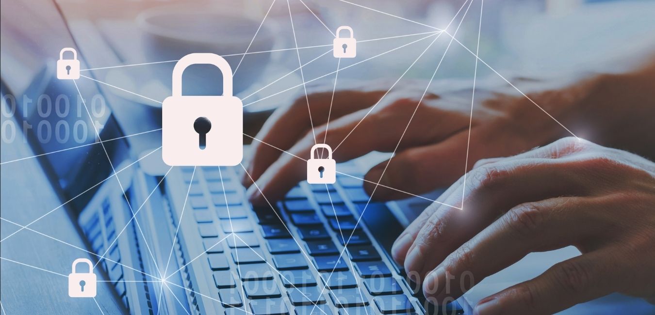Hands typing on a laptop with network security padlock icons